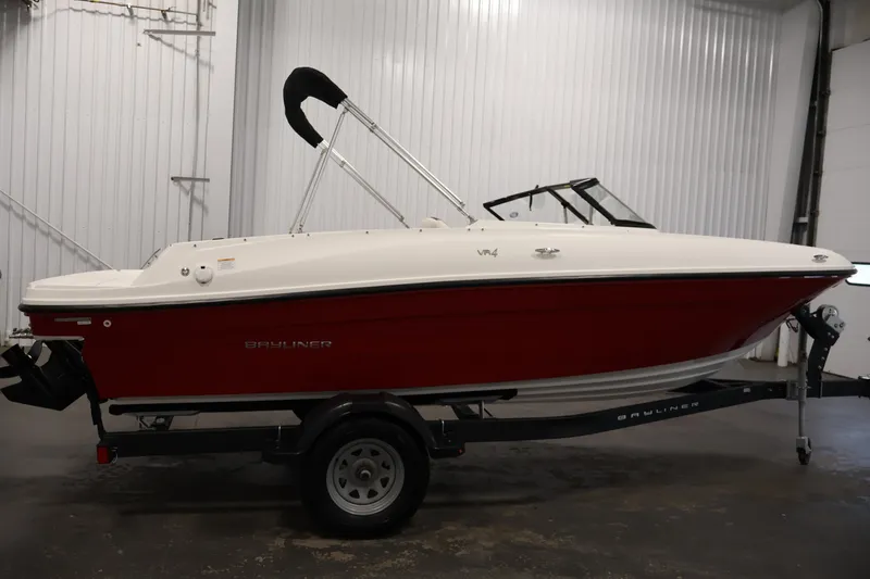 Slide: The Image of 2020 Bayliner VR4 Bowrider I/O in a showroom, featuring a sleek red and white design. - 4