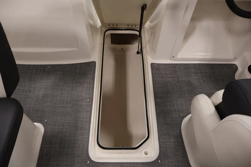 Slide: The Image of 2020 Bayliner VR4 Bowrider I/O interior storage compartment with gray carpet flooring. - 32