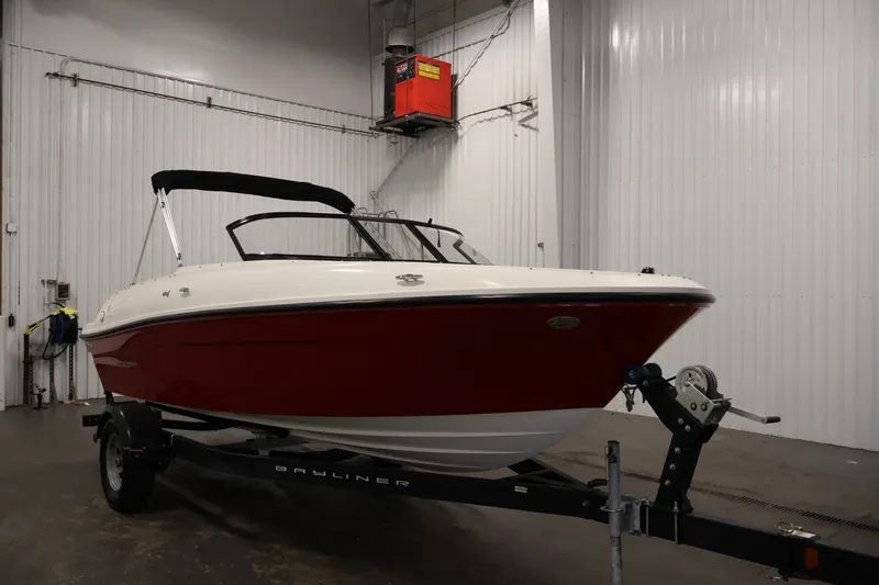 Slide: The Image of 2020 Bayliner VR4 Bowrider I/O in a garage, red and white exterior. - 3