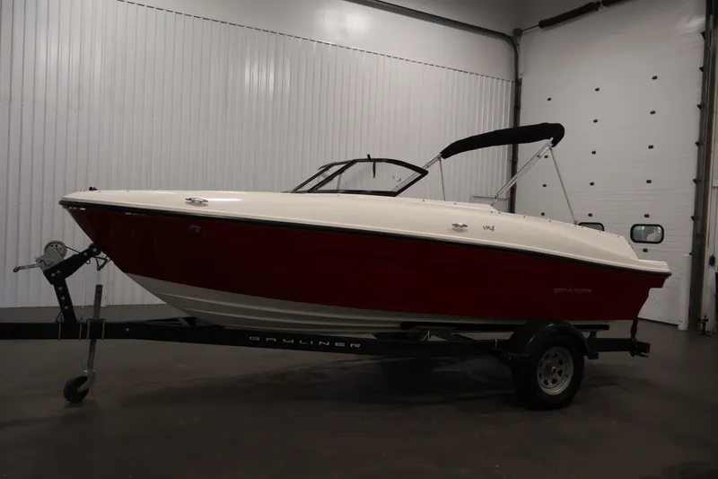 Slide: The Image of 2020 Bayliner VR4 Bowrider I/O in a showroom, red and white exterior on a trailer. - 8