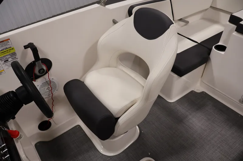 Slide: The Image of 2020 Bayliner VR4 Bowrider I/O interior with steering wheel and cushioned seating. - 29