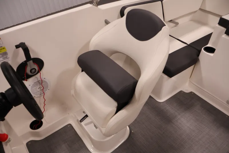 Slide: The Image of 2020 Bayliner VR4 Bowrider I/O interior with steering wheel and cushioned seating. - 30