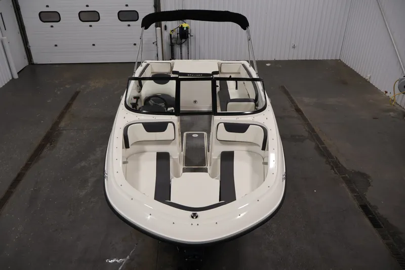 Slide: The Image of 2020 Bayliner VR4 Bowrider I/O in a garage, showcasing spacious seating and sleek design. - 9