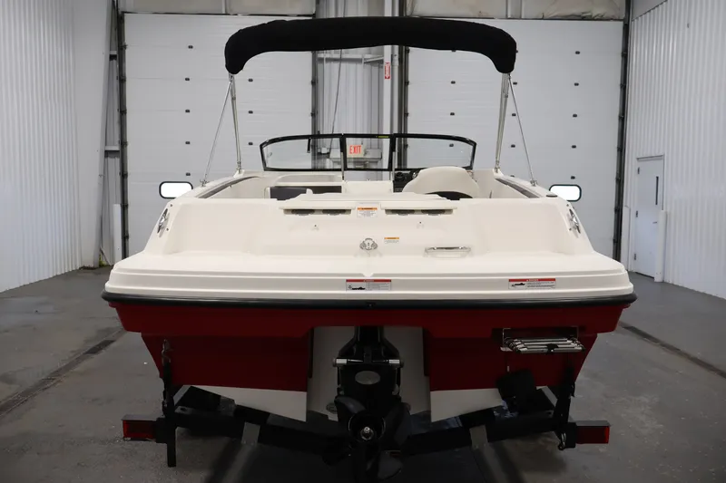 Slide: The Image of 2020 Bayliner VR4 Bowrider I/O boat in a garage, rear view with black canopy. - 6