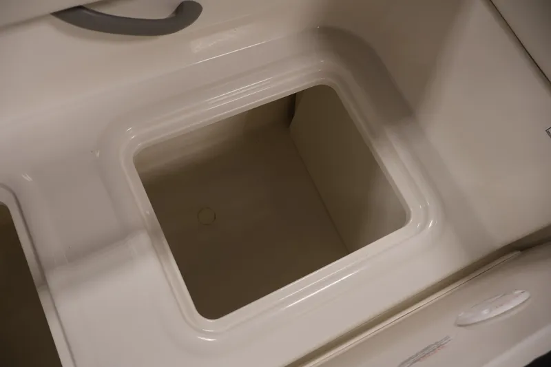 Slide: The Image of 2020 Bayliner VR4 Bowrider I/O storage compartment, white interior, open lid view. - 40
