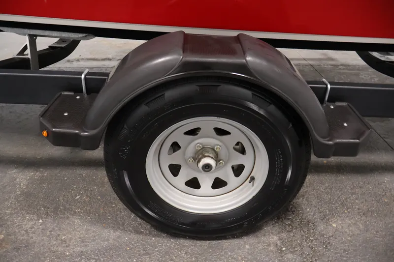 Slide: The Image of Trailer wheel of 2020 Bayliner VR4 Bowrider I/O boat, featuring black fender and step. - 48