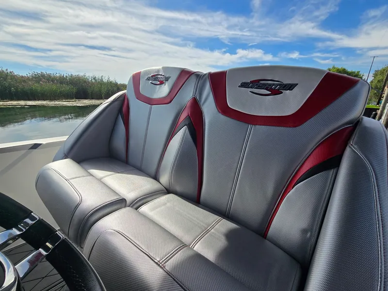 Slide: The Image of The 2017 Sunsation 32 CCX features stylish gray and red seating with the Sunsation logo. - 9