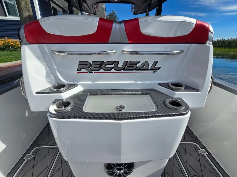 Slide: The Image of The image shows the stern of a 2017 Sunsation 32 CCX boat with red and white seating. - 7