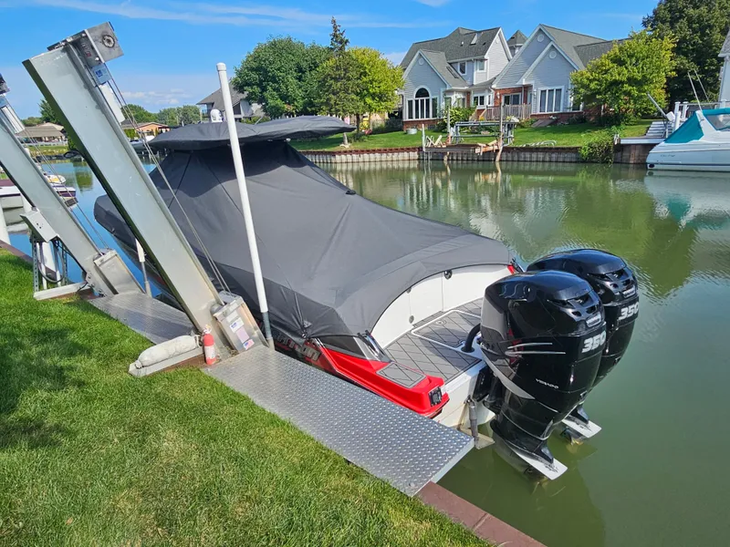 Slide: The Image of A 2017 Sunsation 32 CCX docked, featuring twin outboard engines and a cover. - 18