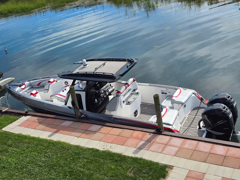 Slide: The Image of A 2017 Sunsation 32 CCX docked. It features a sleek design with red accents. - 2
