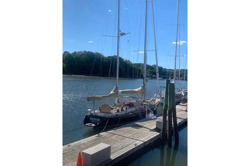 Slide: The Image of 1984 Ta Shing Skye 54 sailboat docked on a sunny day by the water. - 0
