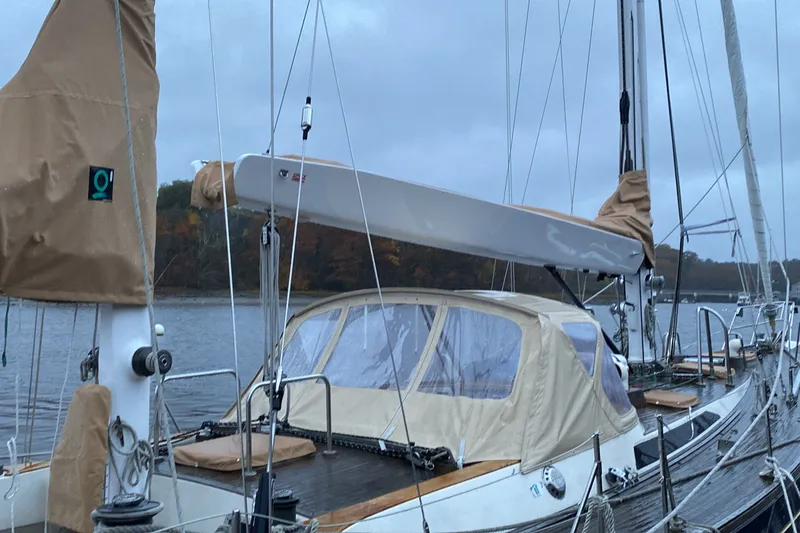 Slide: The Image of 1984 Ta Shing Skye 54 sailboat docked on a calm lake under overcast skies. - 6
