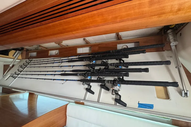 Slide: The Image of Fishing rods stored on a 2001 Southern Composite Sportfish boat interior. - 19