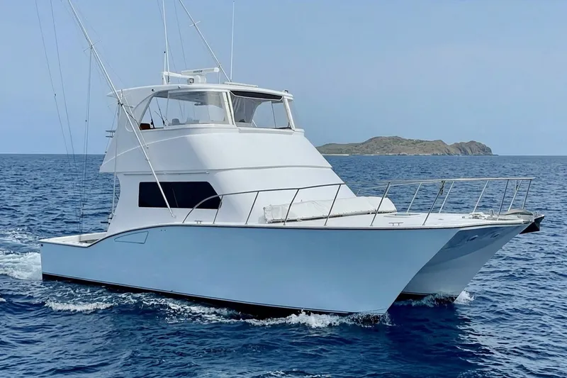 The Image of 2001 Southern Composite Sportfish boat cruising on open sea near an island. - 0