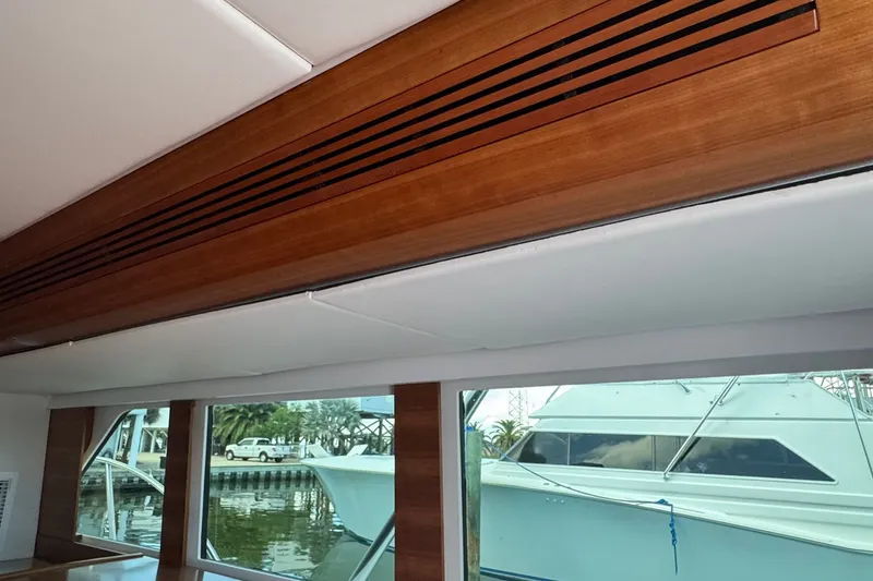 Slide: The Image of Interior view of a 2001 Southern Composite Sportfish boat with wooden paneling and large windows. - 18