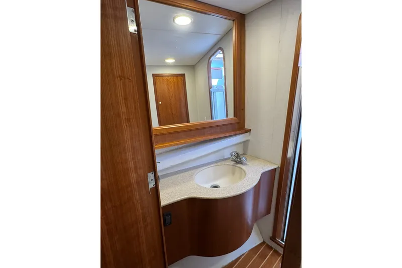 Slide: The Image of 2001 Southern Composite Sportfish bathroom with wooden cabinetry and modern sink design. - 22