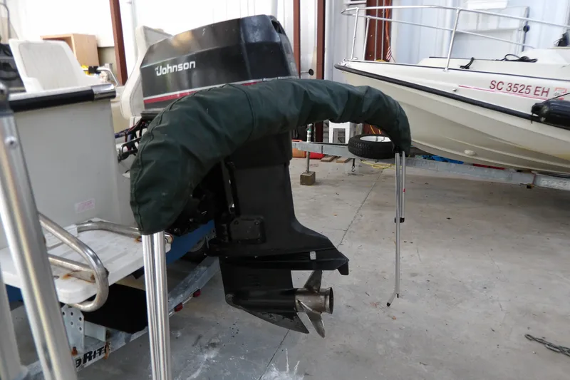 Slide: The Image of 2000 Starcraft C-Star 170 DC boat with Johnson outboard motor in storage. - 20