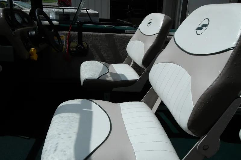 Slide: The Image of Interior of a 2000 Starcraft C-Star 170 DC boat with white and gray seating. - 17