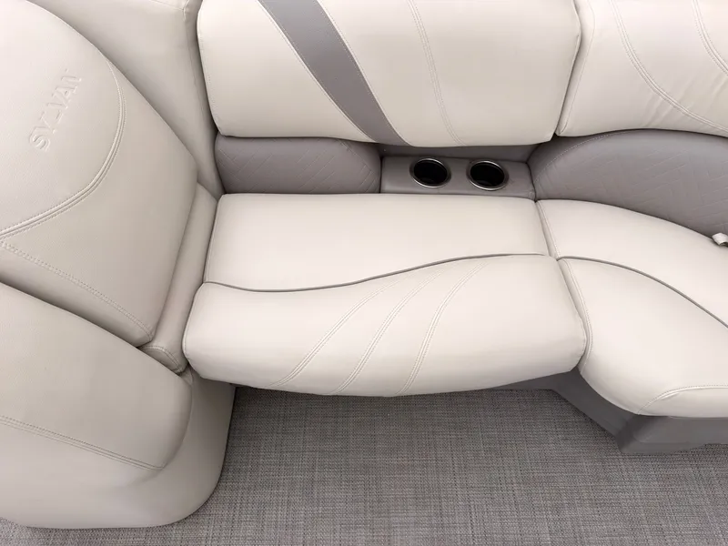 Slide: The Image of The seating area of the 2017 Sylvan Mirage 8524 DL features cream upholstery with cup holders. - 17