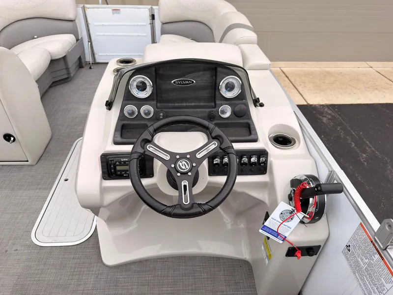 Slide: The Image of The image shows the helm of a 2017 Sylvan MIRAGE 8524 DL with a modern steering wheel and instruments. - 29