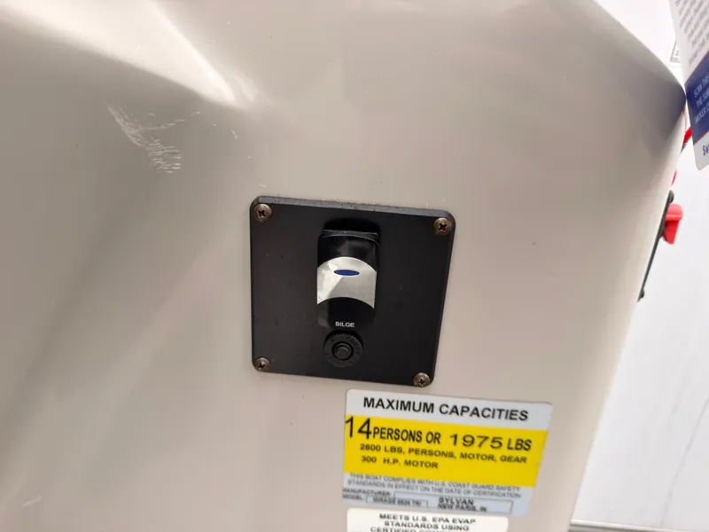 Slide: The Image of Close-up of a switch with a label for maximum capacity of 14 persons or 1975 pounds. - 36