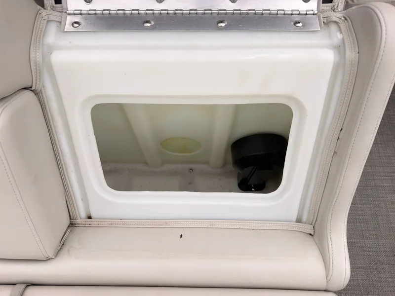 Slide: The Image of An open storage compartment in a boat with beige upholstery. - 47
