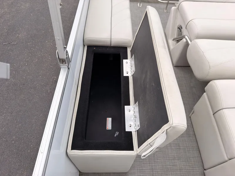 Slide: The Image of An open storage compartment in a white seat on a boat. - 42