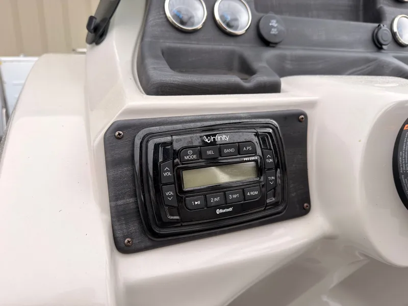 Slide: The Image of Close-up of a boat console area featuring an Infinity audio system and several gauges. - 30