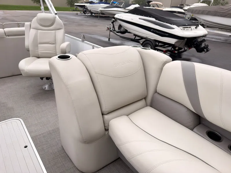 Slide: The Image of The image shows the interior of a 2017 Sylvan MIRAGE 8524 DL with beige leather seating. - 19