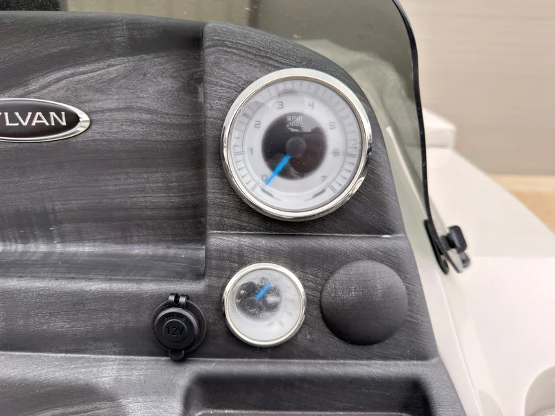 Slide: The Image of Close-up of a boat dashboard with a tachometer and 12V outlet. - 33