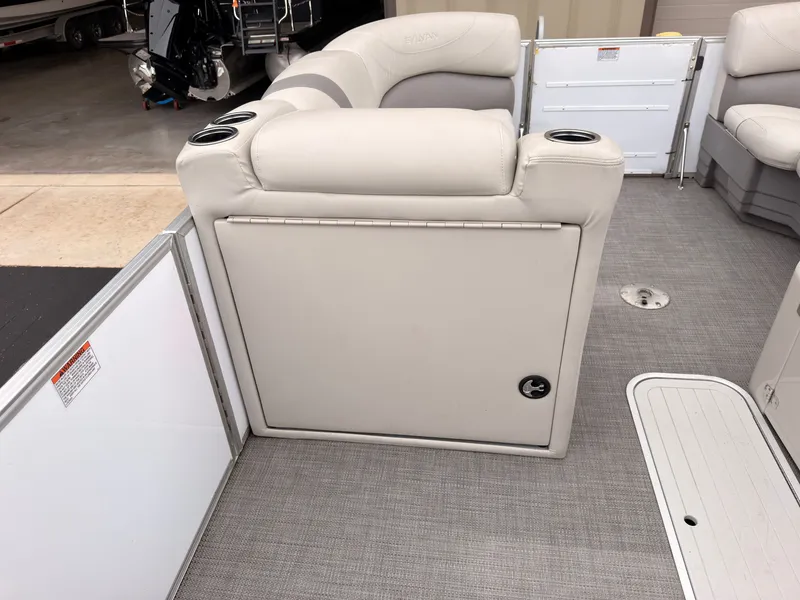 Slide: The Image of The image shows the interior of a 2017 Sylvan Mirage 8524 DL with gray upholstery and cup holders. - 24