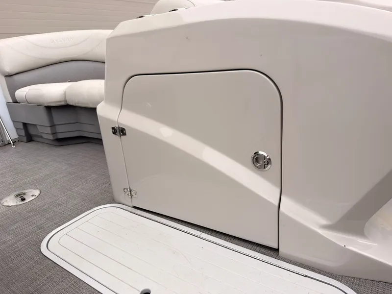 Slide: The Image of The image shows the cockpit of a 2017 Sylvan Mirage 8524 DL with a white door and gray flooring. - 22