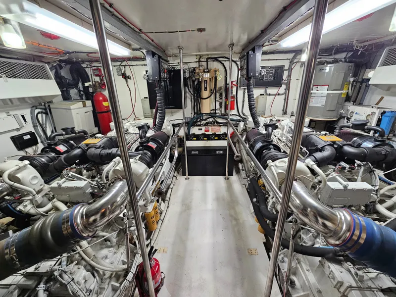 Slide: The Image of The engine room of a 1991 Hatteras 70 Cockpit Motor Yacht features two large engines. - 20