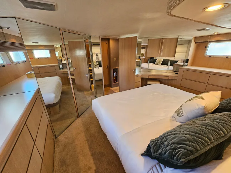 Slide: The Image of Interior of a 1991 Hatteras 70 Cockpit Motor Yacht featuring a cozy bedroom. - 4