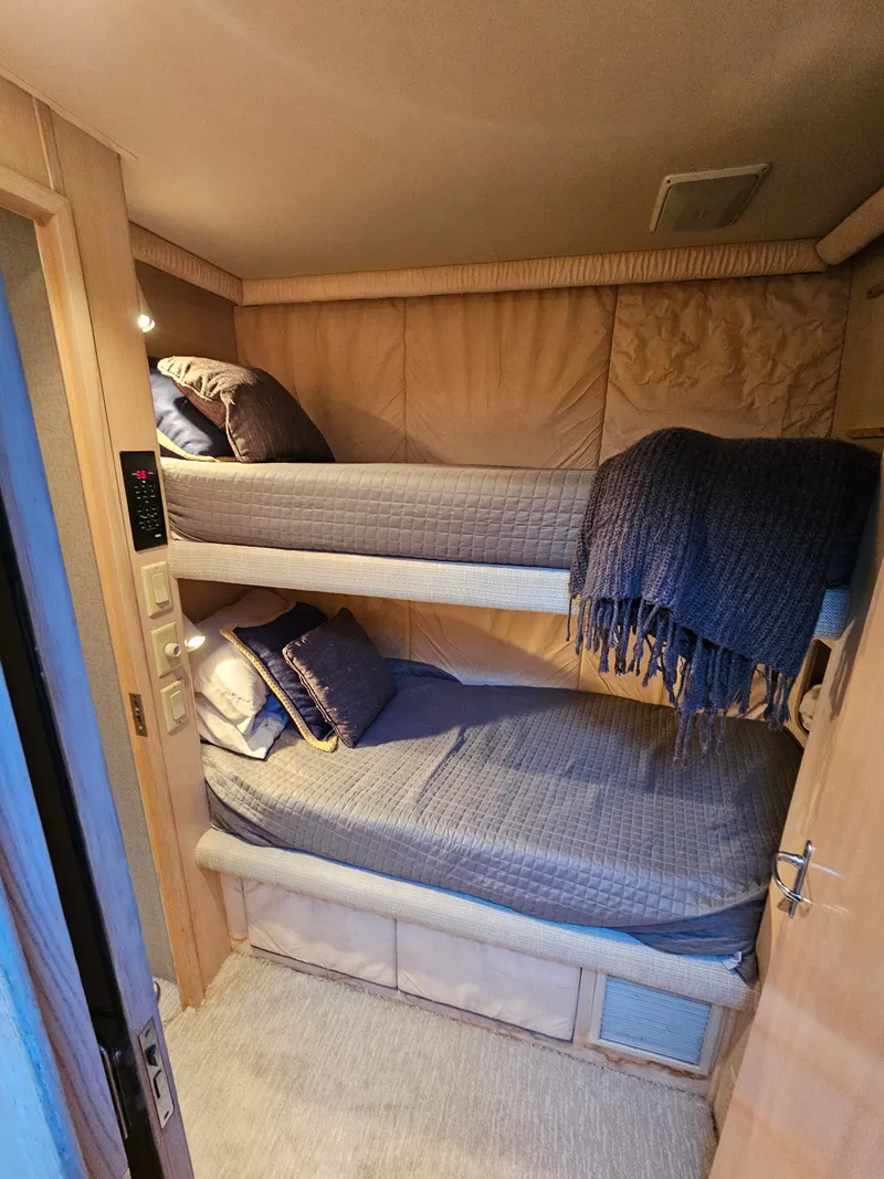 Slide: The Image of Cabin with bunk beds and blue blankets. - 17