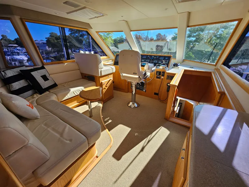 Slide: The Image of Interior of a 1991 Hatteras 70 Cockpit Motor Yacht with comfortable seating and helm station. - 1