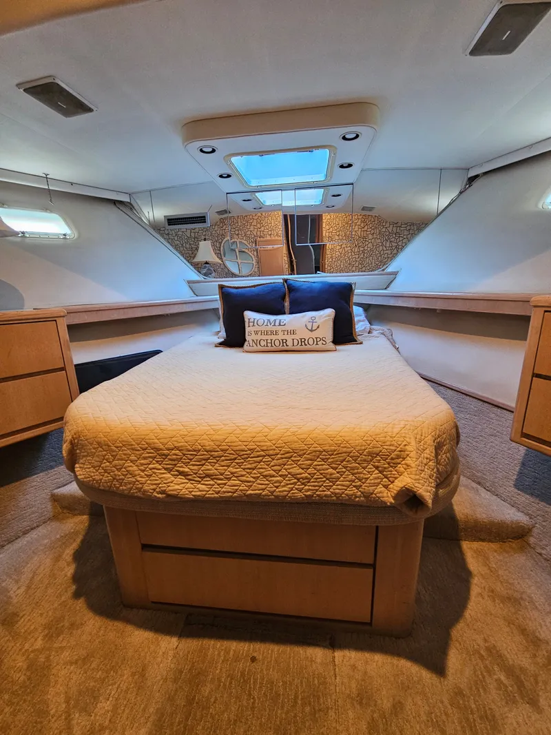 Slide: The Image of The image shows a cozy cabin with a double bed, wooden furniture, and a skylight. - 18