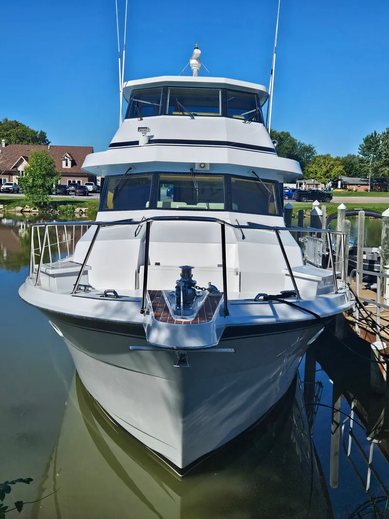 Slide: The Image of A 1991 Hatteras 70 Cockpit Motor Yacht docked in a calm marina. - 6
