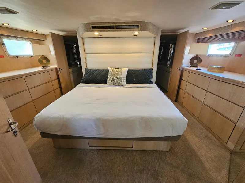 Slide: The Image of The image shows a luxurious cabin with a large bed, wooden furnishings, and two windows. - 19
