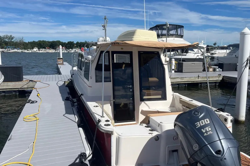 Slide: The Image of 2022 Ranger Tugs R-27 docked, featuring a Yamaha 300 V6 outboard motor. - 3