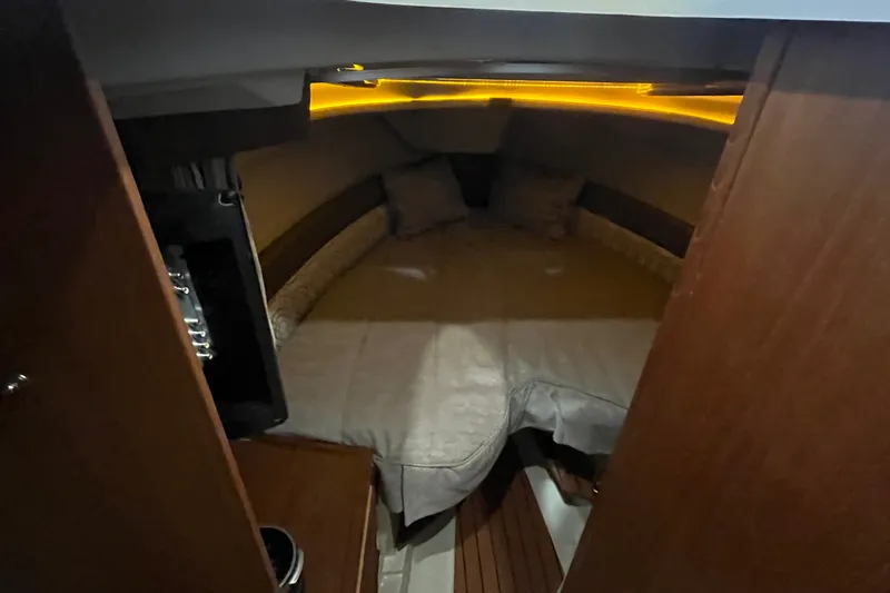 Slide: The Image of Cozy cabin interior of 2022 Ranger Tugs R-27 with ambient lighting. - 12