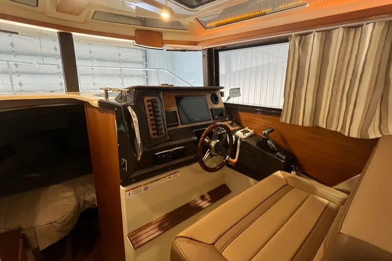 Slide: The Image of Interior of 2022 Ranger Tugs R-27 boat, featuring helm station and comfortable seating. - 15