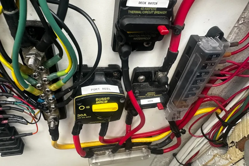 Slide: The Image of Electrical wiring and circuit breakers in a 1996 Carolina Classic 28 boat. - 2
