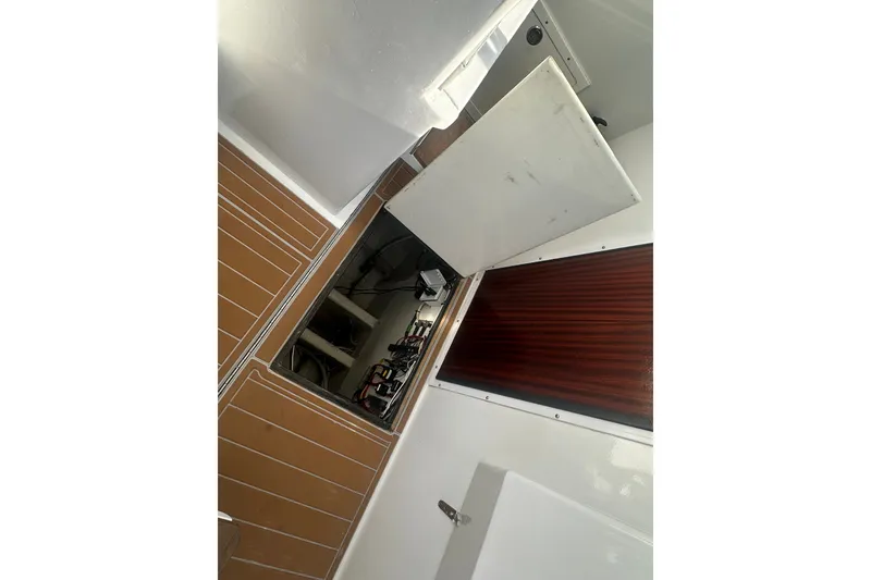 Slide: The Image of 1996 Carolina Classic 28 boat interior showing open hatch and engine compartment. - 3
