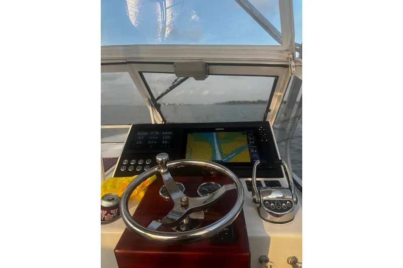 Slide: The Image of Helm of 1996 Carolina Classic 28 boat with navigation display and steering wheel. - 7