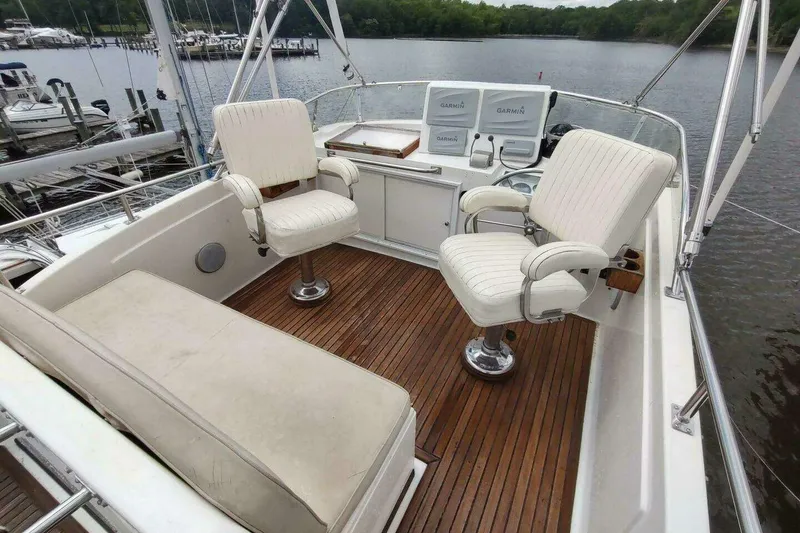 Slide: The Image of Flybridge of 1996 Grand Banks Eastbay 40 with white seating and wooden deck. - 16