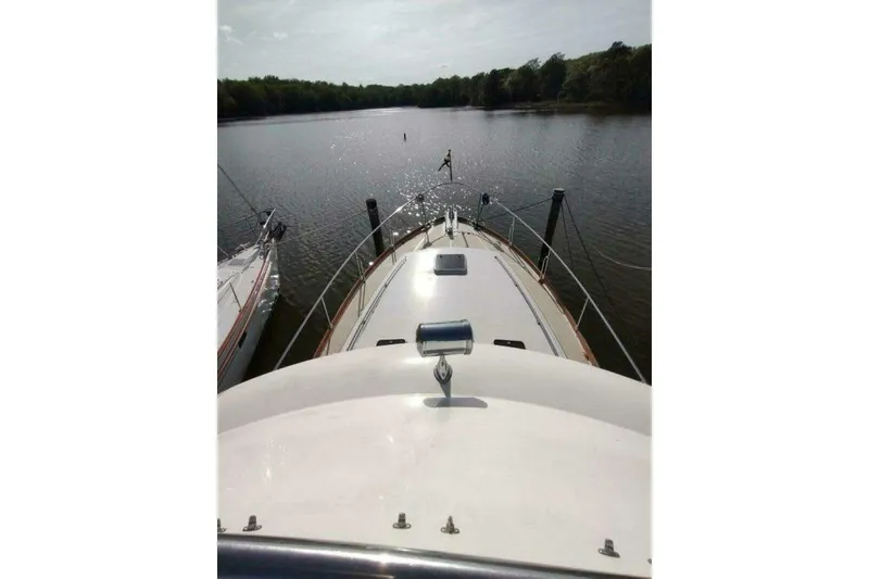 Slide: The Image of 1996 Grand Banks Eastbay 40 Flybridge on calm river, view from bow. - 94