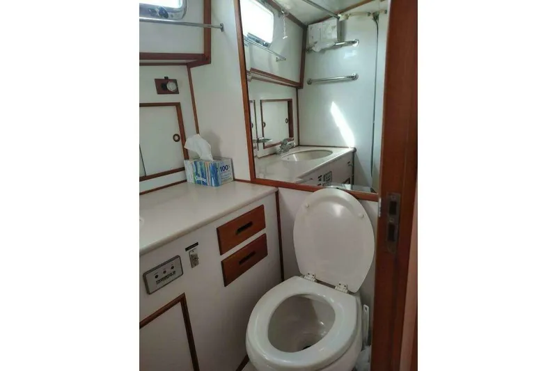 Slide: The Image of Bathroom interior of 1996 Grand Banks Eastbay 40 Flybridge yacht, featuring toilet and sink. - 73