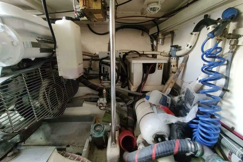 Slide: The Image of Engine room of 1996 Grand Banks Eastbay 40 Flybridge with various mechanical components. - 84