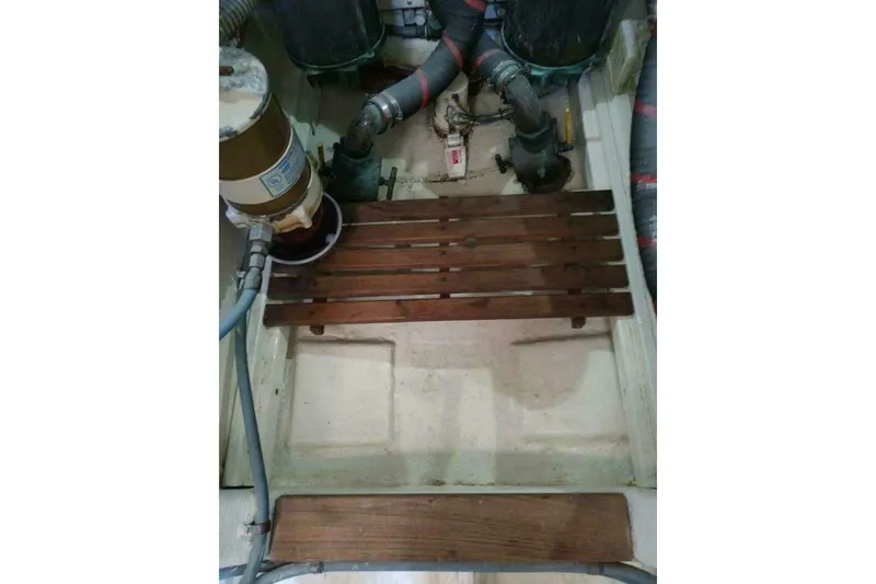 Slide: The Image of Engine room of 1996 Grand Banks Eastbay 40 Flybridge with wooden slats and mechanical components. - 76